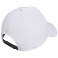 A white baseball cap is positioned upside down showing its back detailing and adjustable strap highlighting its smooth fabric texture in a neutral setting