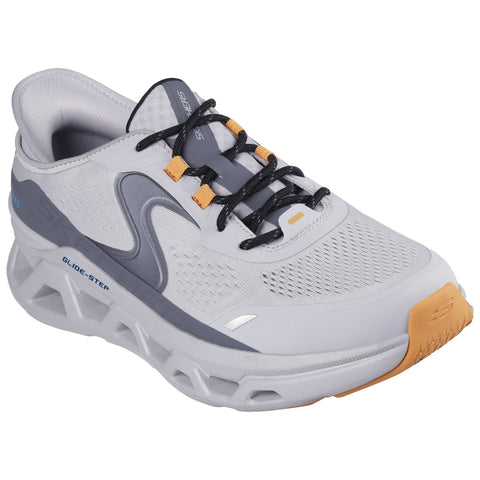 A gray and white athletic shoe is positioned prominently with laces secured and padding visible the shoe has a cushioned sole and features the brand name on the side.