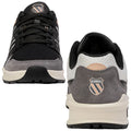 A pair of sporty shoes is displayed from the front and back view featuring a black mesh upper with gray and white accents and a logo on the heel.