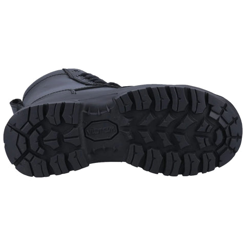 A black boot with a rugged, textured sole rests on a flat surface displaying deep treads designed for traction in various terrains suggesting durability and practicality for outdoor activities.