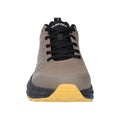 A beige and gray athletic shoe is positioned facing forward with black laces and a distinctive yellow sole showcasing its rugged design for outdoor activities in a neutral background.