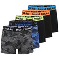 Five pairs of men's boxer briefs are displayed in a row featuring various colors and camouflage patterns. Each pair has a distinct elastic waistband labeled "Hard Yakka."