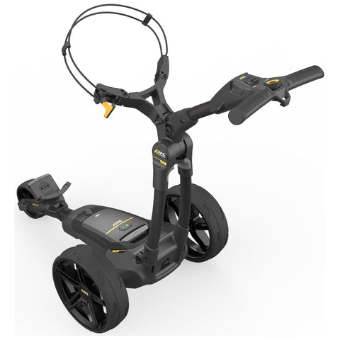 A Powakaddy FX1 golf trolley designed for easy transport features a compact frame with two large wheels and a handle for steering. It includes controls on the handle for functionality in outdoor settings.