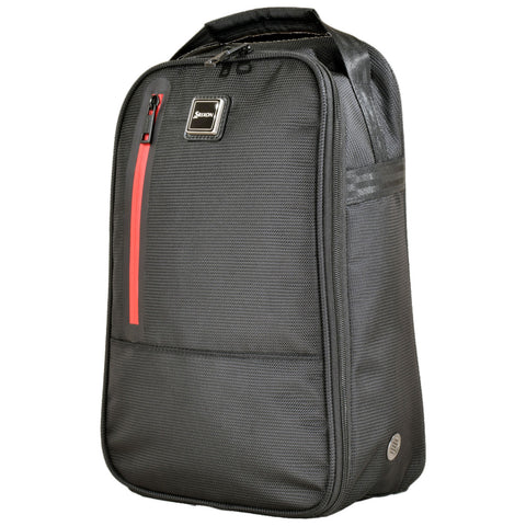 A black backpack stands upright featuring a red zipper accent and textured fabric with multiple compartments designed for carrying belongings in various settings like school or travel.