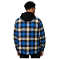 A person is seen from behind wearing a checkered blue and black flannel shirt with a black hood. The background is plain and white, emphasizing the clothing.