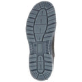 A rubber shoe sole is shown resting on a flat surface with textured traction patterns and written information indicating features and branding details underneath the arch area.