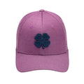 A purple baseball cap features a dark navy four-leaf clover logo prominently on the front it rests flat with a curved brim in a simple background