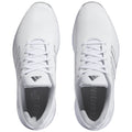 White athletic shoes feature a textured upper and matching laces with small black accents and branding on the tongue and side. The interior includes a cushioned sole for comfort.