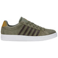 A green suede sneaker with brown stripes and a tan heel tab sits horizontally against a plain background showcasing a casual athletic style suitable for daily wear or light sports.