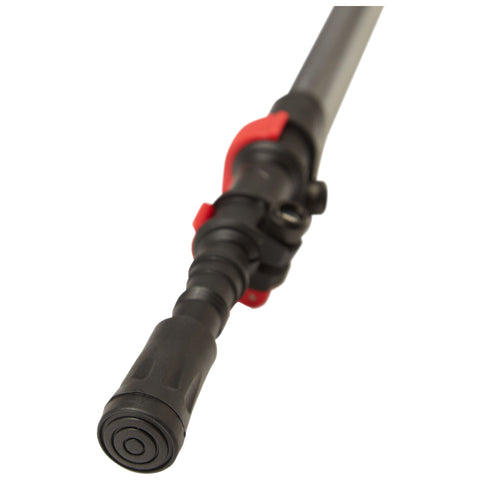 A black and red pressure washer wand is angled toward the viewer featuring a textured grip and a nozzle for directing water in outdoor cleaning tasks.