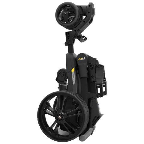 A black and gray golf trolley is upright and folded displaying large wheels and a handle it is designed for easy transport and storage on golf courses.