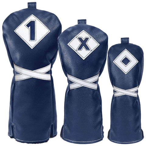 Three golf club headcovers made of textured navy leather are displayed. Each cover is labeled with a different symbol: a number one a letter X and a diamond shape.