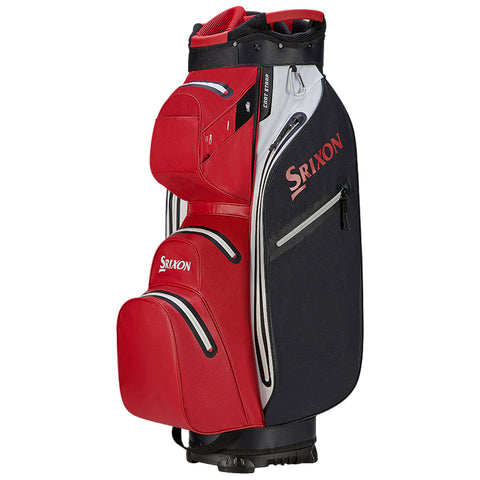 A golf bag is standing upright featuring a black body with red accents and multiple zippered pockets showcasing the brand name Srixon prominently on the side and top.