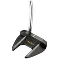 A black golf putter with a unique head design rests upright with a shiny chrome shaft in a plain white background suggesting an emphasis on the equipment's details and craftsmanship.