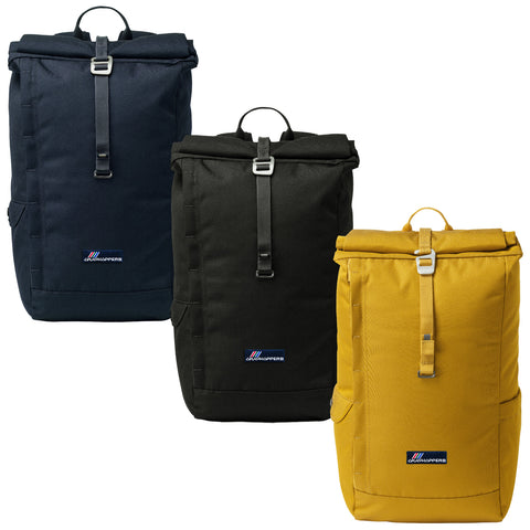 Three backpacks are displayed in a row featuring a navy blue one on the left a black one in the center and a yellow one on the right showcasing a roll-top design and adjustable straps