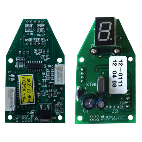 Two electronic circuit boards with various components arranged on a green surface display labeled elements and connectors with one board featuring a seven-segment display showing the number eight