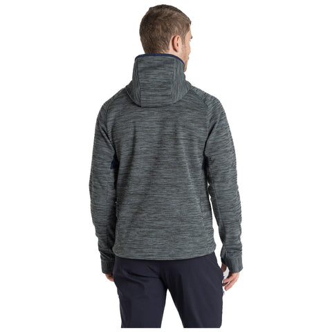 A person wearing a dark, textured hoodie is standing with their back turned. The environment suggests an outdoor or casual setting, highlighting the comfortable and sporty nature of the clothing.