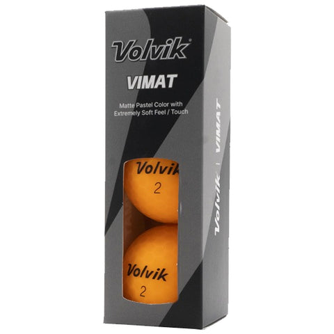 Two orange golf balls labeled Volvik 2 are displayed within a transparent window of a black and gray rectangular box. The box features branding and product information.