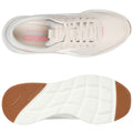 A light beige athletic shoe sits flat showcasing its lightweight mesh upper and a textured rubber sole. The design highlights the brand name and features a pink memory foam label inside.