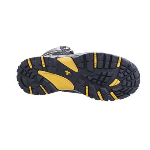 A rugged shoe sole features deep treads and yellow accents indicating traction and durability designed for outdoor use on uneven terrain viewed against a plain white background.