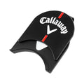 A black golf ball marker shaped like a clamshell displays the logo Callaway with a white V and red lines indicating measurement it is likely used for marking balls on the green