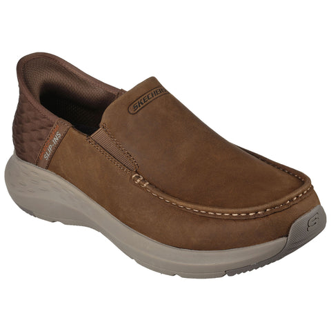 A brown slip-on shoe with a smooth leather upper and elastic side panels is positioned on a neutral background showcasing its comfortable design ideal for casual wear.