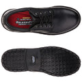 A black shoe with laces sits flat with a textured sole visible below. The inside has red padding labeled with "SKECHERS RELAXEDFIT MEMORY FOAM."