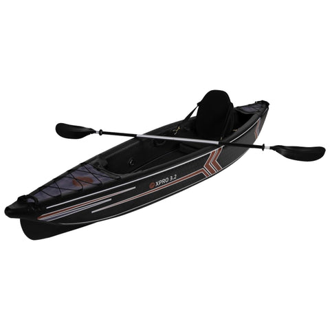 A black kayak with red and white accents is positioned at an angle showing its design it features a seating area and two paddles resting alongside ready for use