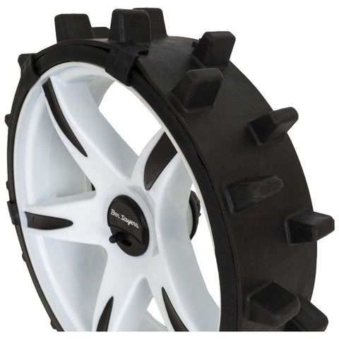 A rubber tire chain consisting of a large triangular piece with spikes and several smaller curved pieces is shown. It is designed for enhancing traction on vehicles in winter conditions.