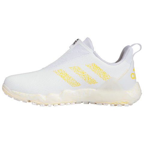 A white athletic shoe with a textured surface features three yellow stripes on the side. It has a slip-on design with a zipper and a rubber sole designed for traction.