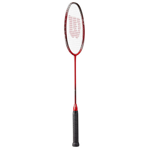 A badminton racket features a long red handle with a black, textured grip and a thin, oval-shaped head. It is designed for striking a shuttlecock during play.