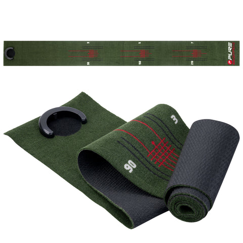 A green measuring tape marked with numbers and grid lines is laid flat while a black curling mat sits rolled beside it along with a round black clip as accessories for use.