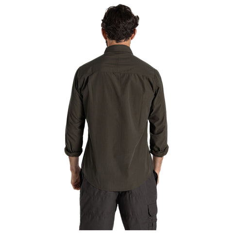 A person wearing a dark green shirt stands with their back facing the viewer in a neutral background, suggesting a casual or outdoor setting.