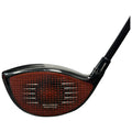 A golf club with a glossy black shaft features a wide, red-tinted head displaying a hexagonal pattern with the text 60X CARBON TWIST FACE positioned prominently on the face.