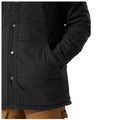 A black jacket is displayed with a hand placed in its pocket suggesting a casual stance in a neutral environment emphasizing comfort and style.