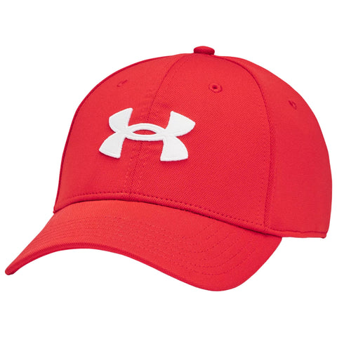 A red baseball cap with a prominent white Under Armour logo positioned on the front rests against a neutral background showcasing its curved brim and structured design.