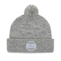 A gray knit beanie with a pom-pom on top is displayed flat its folded brim features a round logo patch labeled Titleist surrounded by a smooth background.