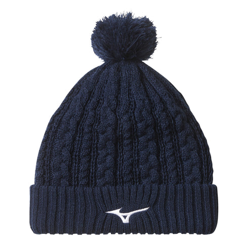 A dark navy knit beanie with a pom-pom on top is displayed against a plain white background showcasing its textured pattern and a white logo stitched on the front.