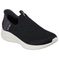 A black slip-on shoe features a textured upper and a white rubber sole designed for comfort and casual wear set against a plain white background.