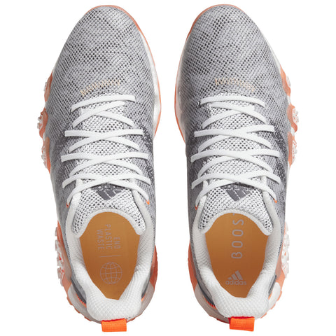 Gray and white athletic shoes with textured mesh uppers feature orange accents and white laces placed centrally on a plain background highlighting their design and materials