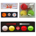 A set of colorful golf balls in festive designs are arranged in two clear boxes indicating a Merry Christmas theme with images of Santa Claus and snowmen The packaging includes decorative elements and holiday greetings.