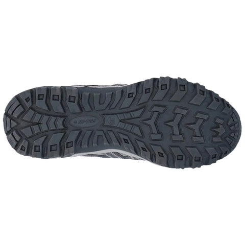 A shoe sole is displayed showcasing a rugged tread pattern designed for traction on various surfaces indicating outdoor or athletic use in a neutral backdrop