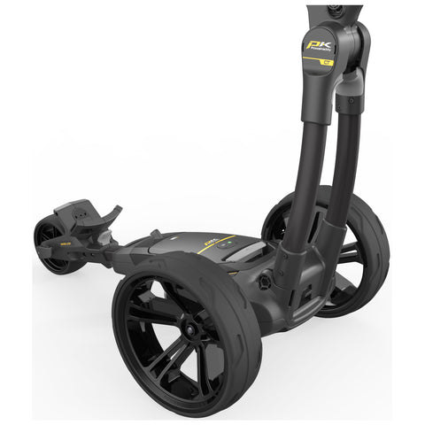 A golf push cart with three large wheels is positioned upright featuring a sleek black and yellow design with a control panel on top ready for use on a golf course.