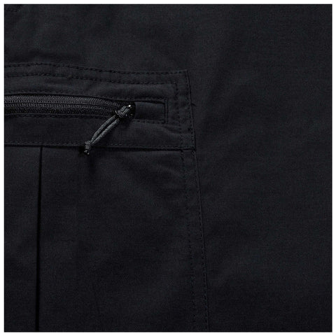 A black fabric panel features a zippered pocket with a pull cord highlighting its utilitarian design and emphasizing simplicity in form and function within a minimalistic context.