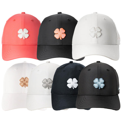 A collection of eight hats arranged in two rows features various colors including coral black white and navy each with a prominent four-leaf clover emblem on the front.