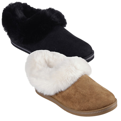 Two pairs of cozy slippers are displayed one black with a fuzzy black collar and the other brown with a fluffy white collar set against a plain background