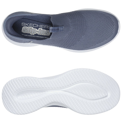 A grey slip-on shoe with a knitted upper rests on a white background showcasing a textured sole below it designed for comfort and traction featuring an "Air-Cooled Memory Foam" insole