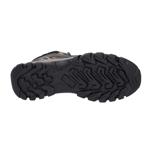 A rugged shoe sole features deep treads designed for traction as it rests on a flat surface, indicating readiness for outdoor activities like hiking or trekking.