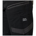 Black work pants featuring multiple pockets and a visible logo reading Hard Yakka along the side suggesting utility and durability in a professional or outdoor setting.