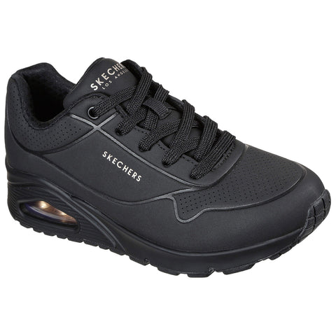 A single black athletic shoe sits upright showcasing a smooth surface and thick soles with a visible air cushion feature highlighting its sporty design intended for comfort and performance.